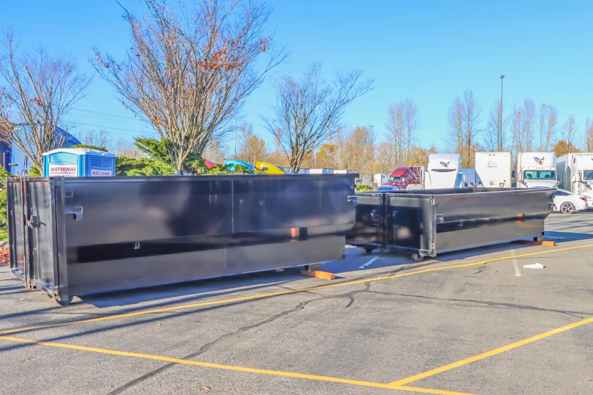 Professional dumpster rental service with roll-off container on residential driveway in Haines City